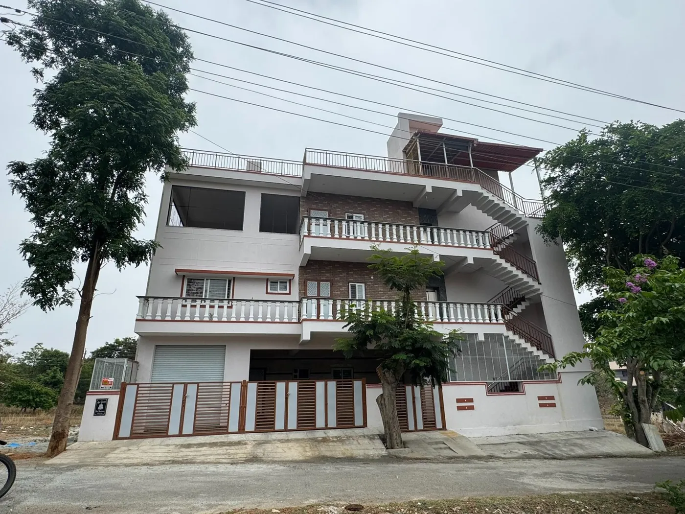 Three-storey white residence with balconies